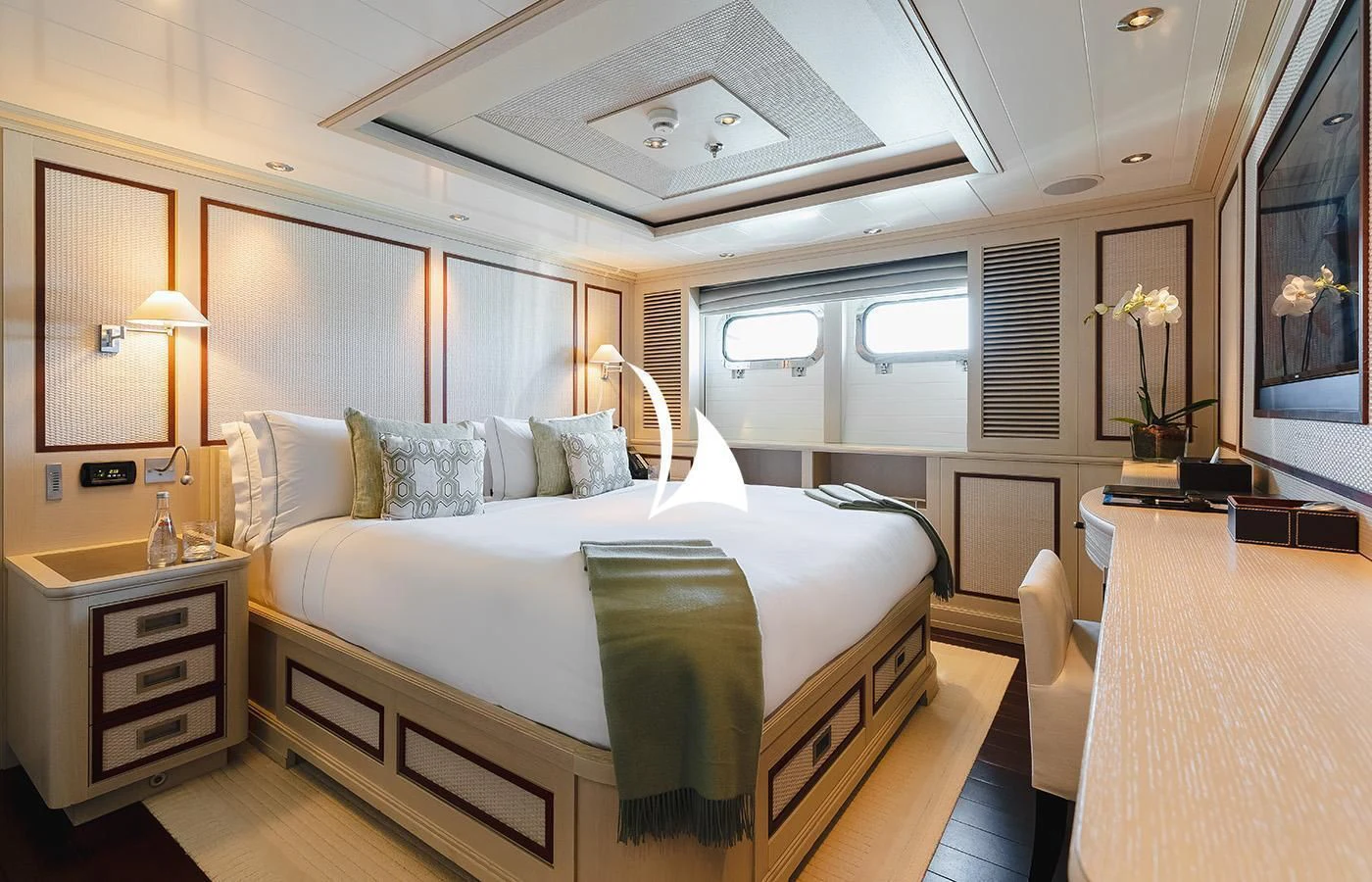 a bedroom with a bed and a desk aboard ODESSA Yacht for Charter
