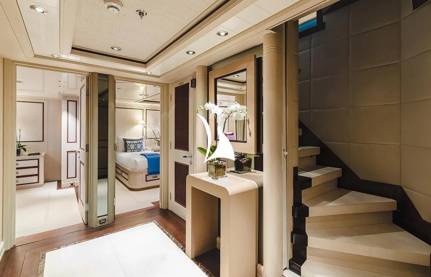 a room with a white bed and a mirror aboard ODESSA Yacht for Charter