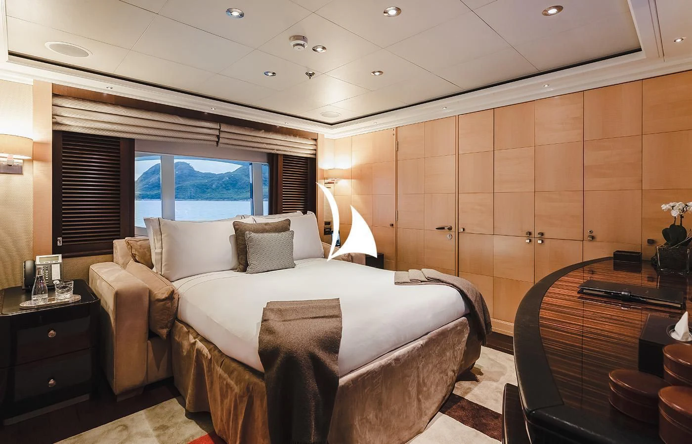 a room with a bed and a desk aboard ODESSA Yacht for Charter