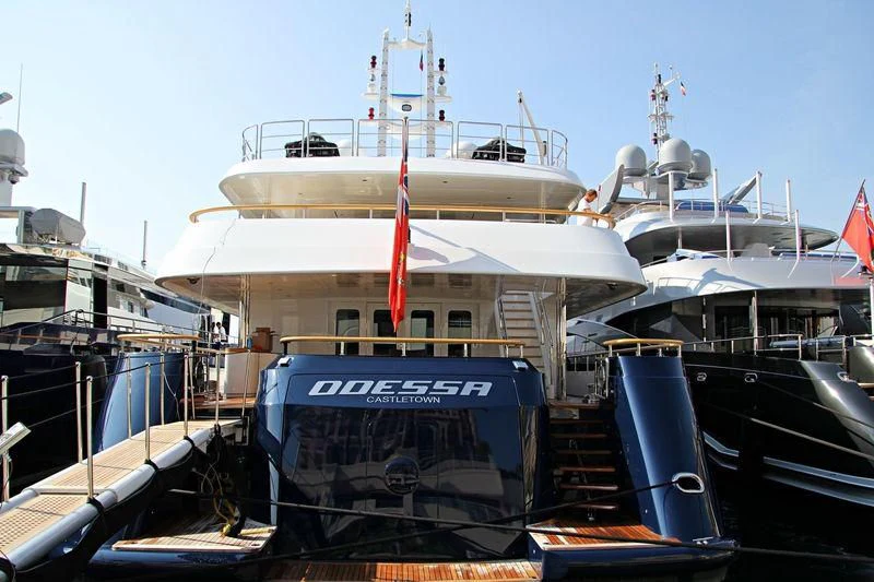 a large white boat sits in a dock aboard ODESSA Yacht for Charter