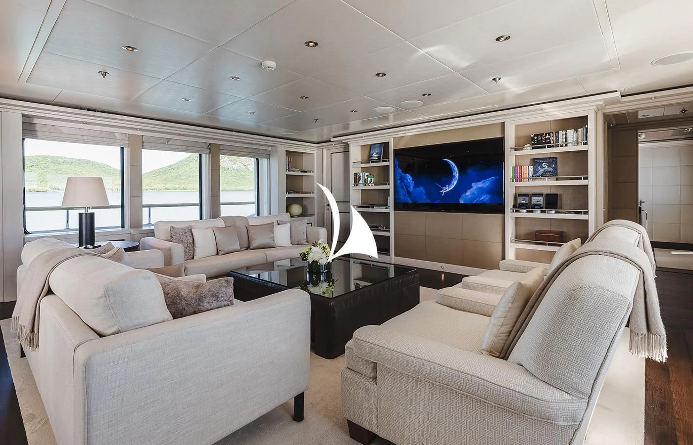 a living room with a large screen aboard ODESSA Yacht for Charter