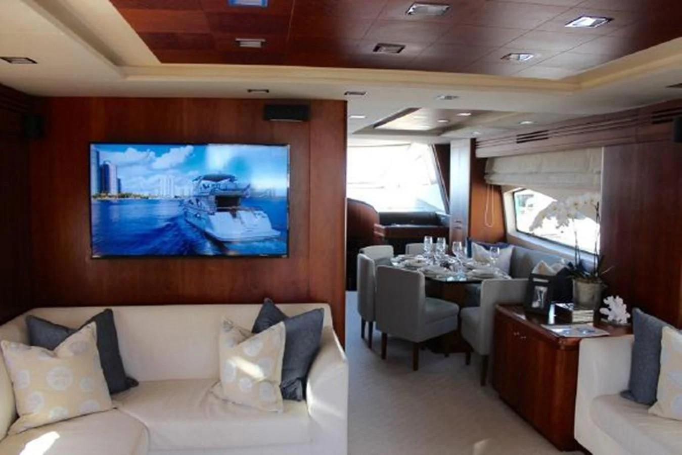 a living room with a large screen aboard PURA VIDA Yacht for Sale