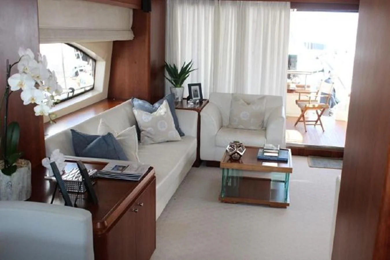 a living room with a couch and a coffee table aboard PURA VIDA Yacht for Sale