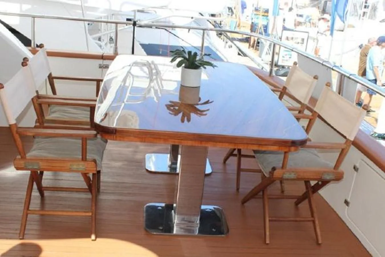 a table with chairs and a vase on it aboard PURA VIDA Yacht for Sale