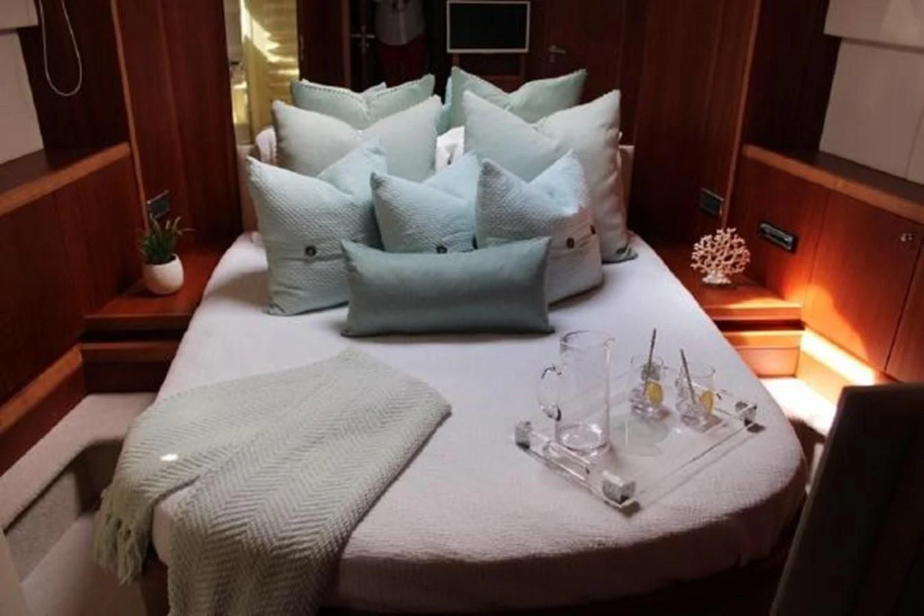 a table with a white cloth and a white pillow on it aboard PURA VIDA Yacht for Sale