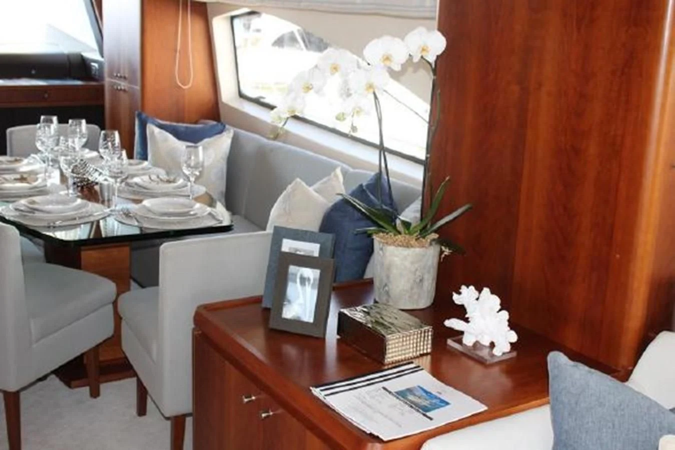 a table with a vase of flowers aboard PURA VIDA Yacht for Sale