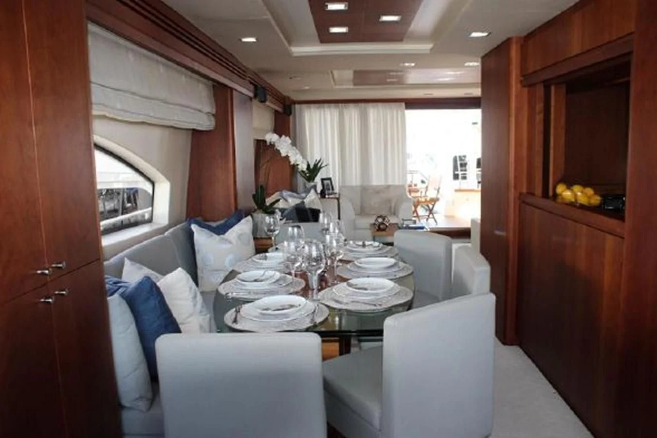 a dining room with a table and chairs aboard PURA VIDA Yacht for Sale