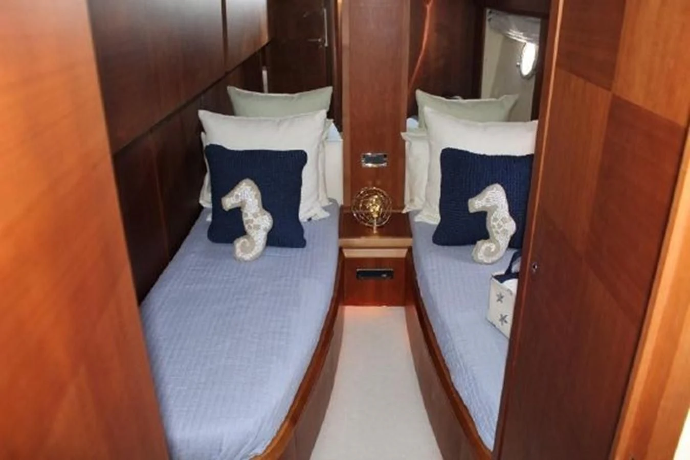 a room with a bed and a dresser aboard PURA VIDA Yacht for Sale