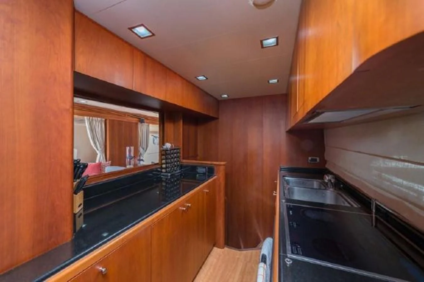 a kitchen with wooden cabinets aboard PURA VIDA Yacht for Sale