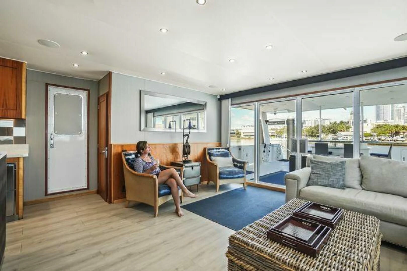 a person sitting in a chair in a living room aboard ISLAND SOUL Yacht for Sale