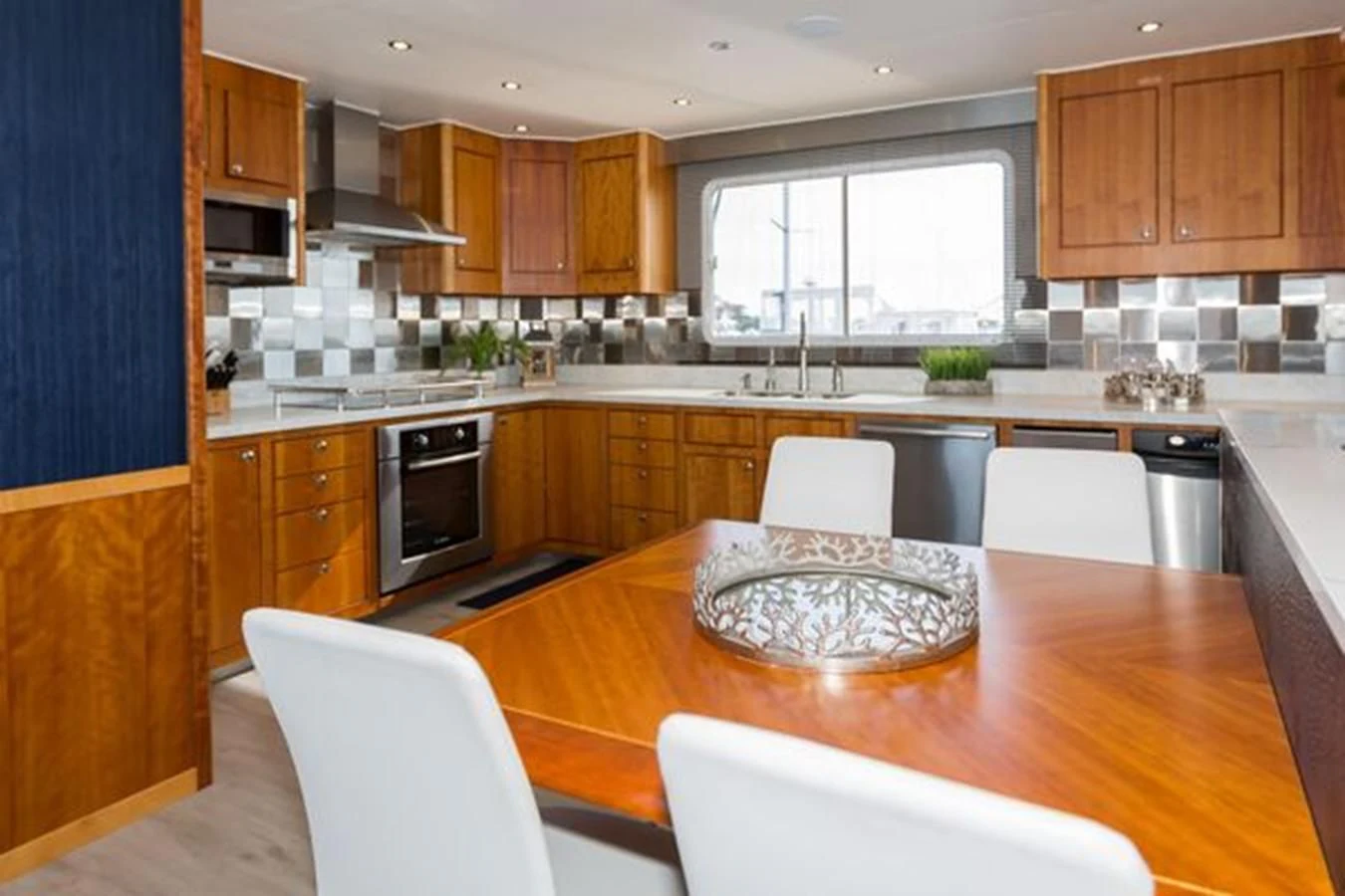 a kitchen with a table and chairs aboard ISLAND SOUL Yacht for Sale