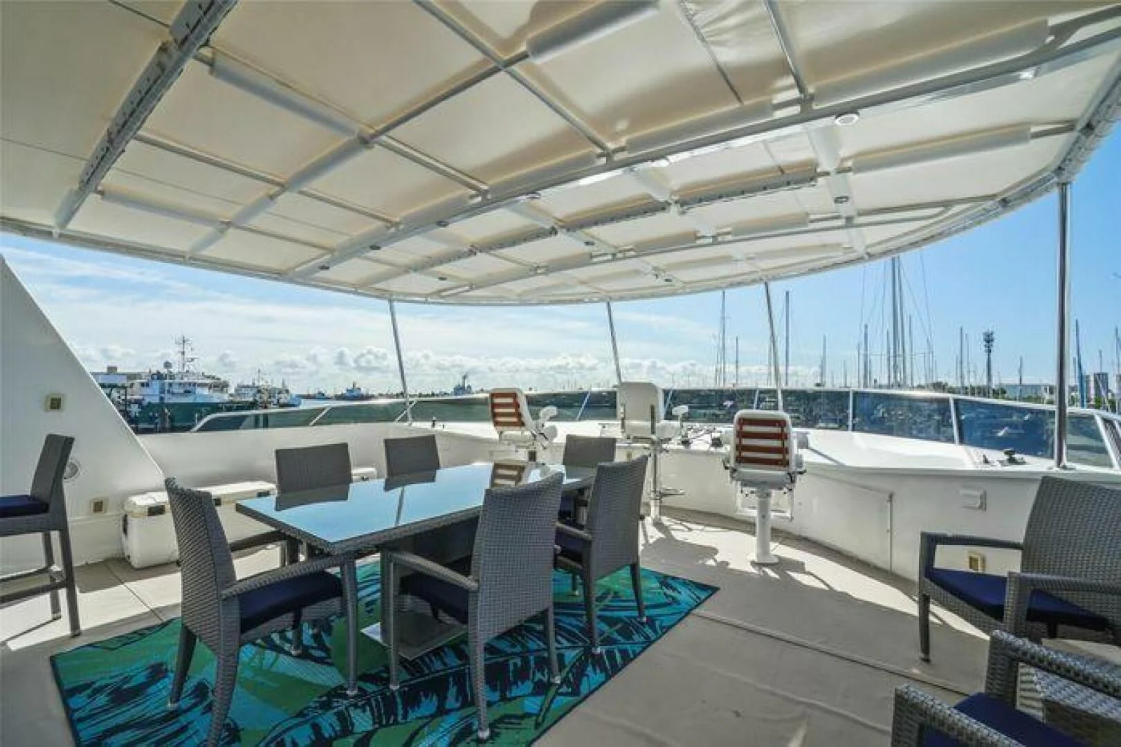 a boat deck with chairs and tables aboard ISLAND SOUL Yacht for Sale