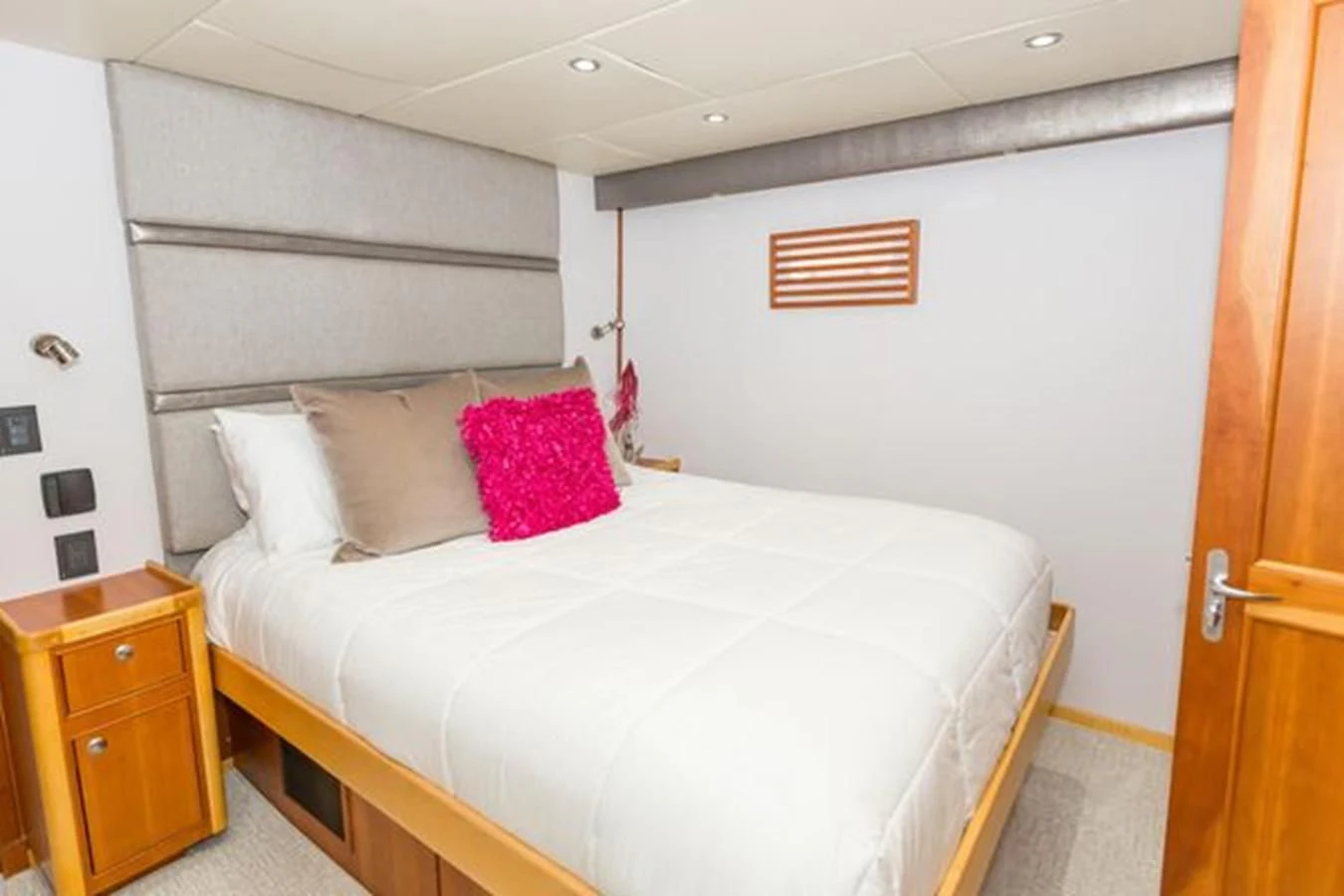 a bedroom with a bed and a dresser aboard ISLAND SOUL Yacht for Sale