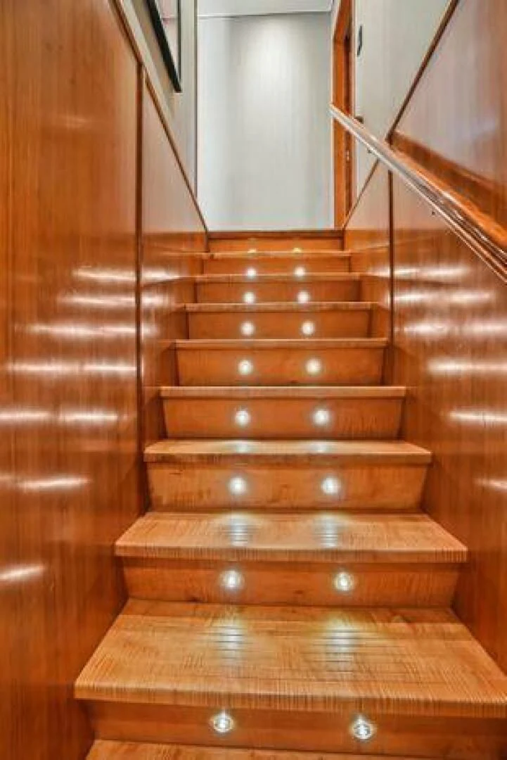 a wooden staircase with a railing aboard ISLAND SOUL Yacht for Sale