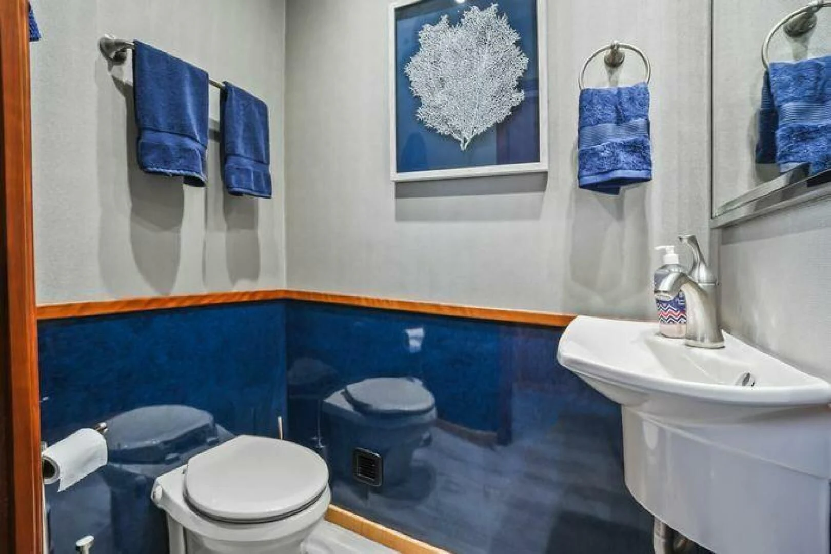 a bathroom with blue towels aboard ISLAND SOUL Yacht for Sale