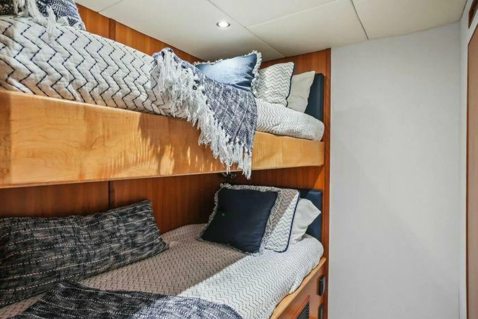 a bed with a blue blanket aboard ISLAND SOUL Yacht for Sale