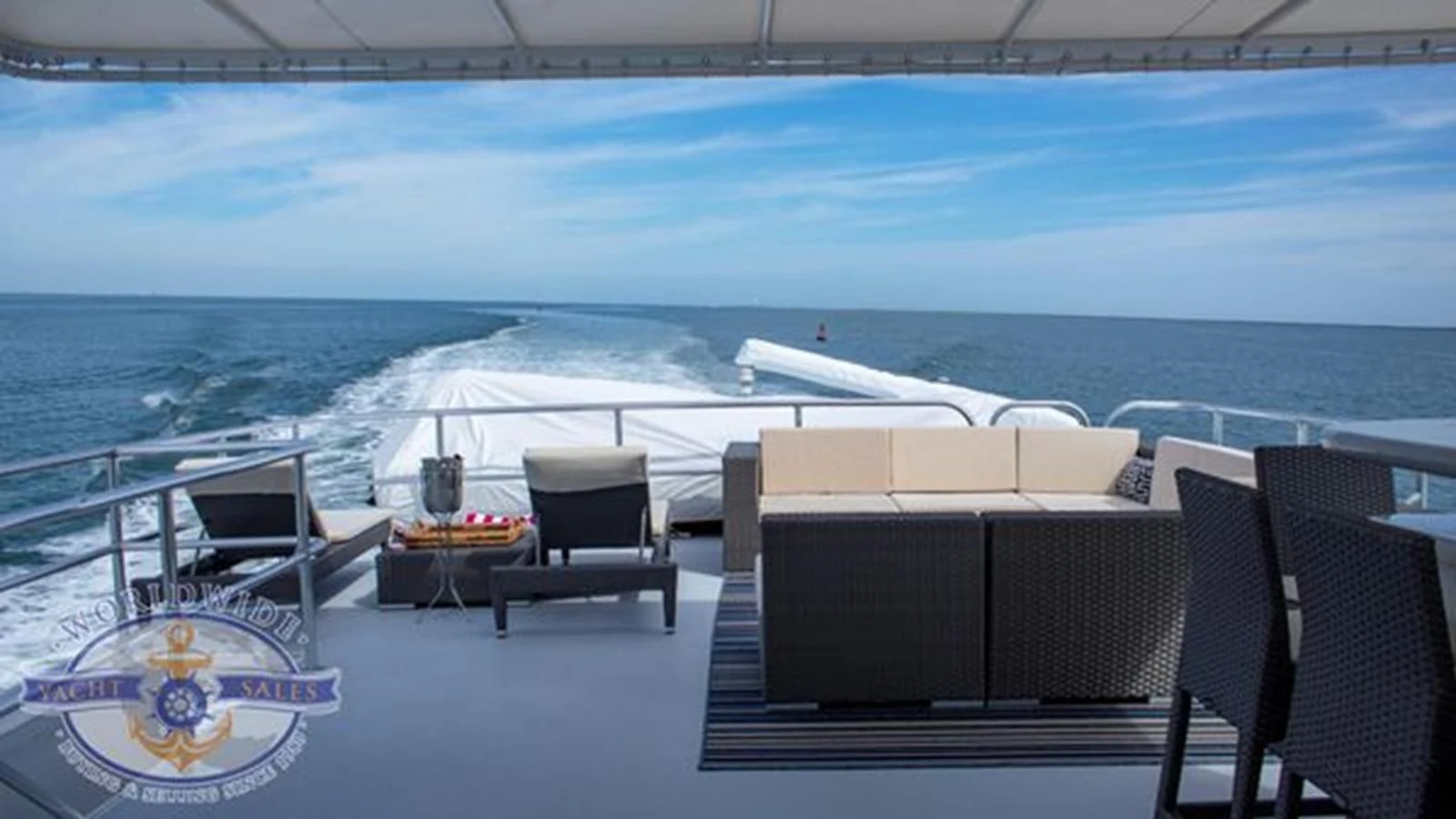 a patio with chairs and tables on it next to a body of water aboard ISLAND SOUL Yacht for Sale