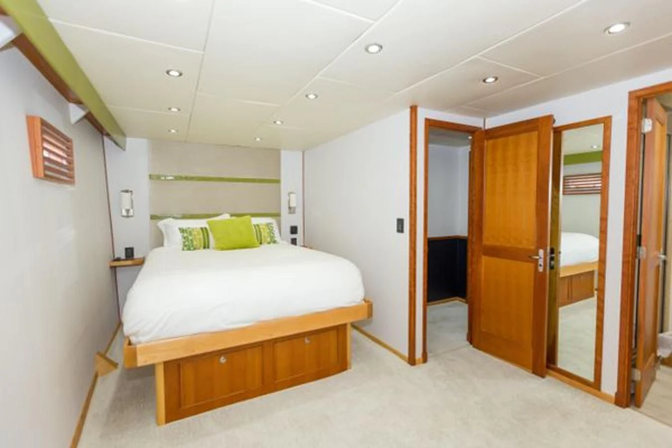 a bedroom with a bed and a closet aboard ISLAND SOUL Yacht for Sale