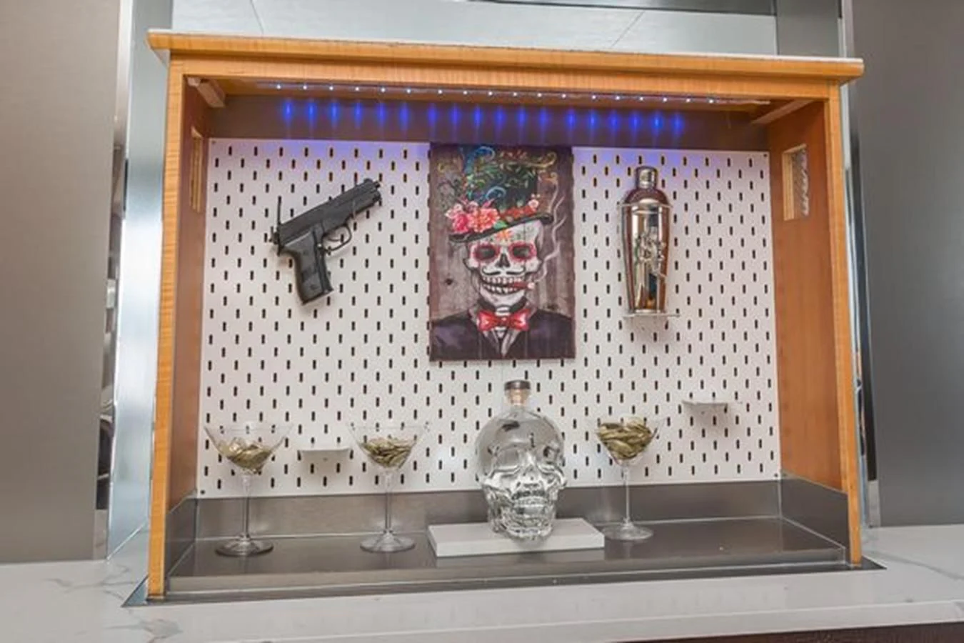 a framed picture of a person in a room with wine glasses and a painting on the wall aboard ISLAND SOUL Yacht for Sale