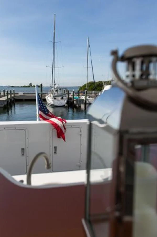 a boat with a flag on the front aboard ISLAND SOUL Yacht for Sale