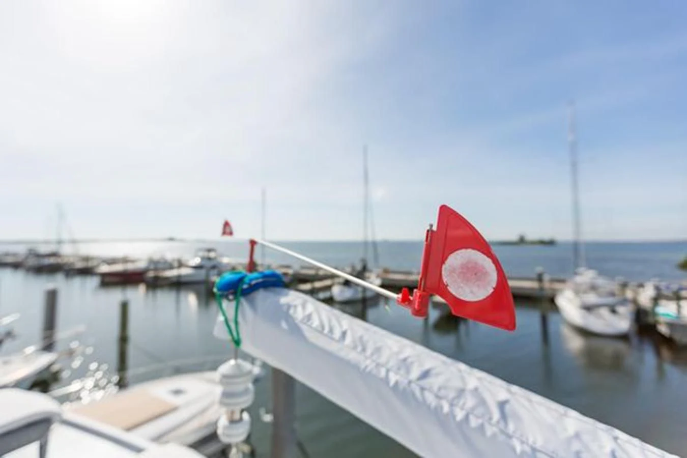 a red and white lantern on a railing over a body of water aboard ISLAND SOUL Yacht for Sale