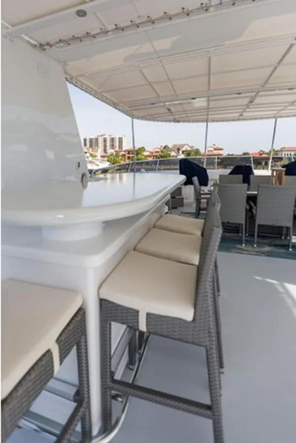 a white lounge chair on a balcony aboard ISLAND SOUL Yacht for Sale