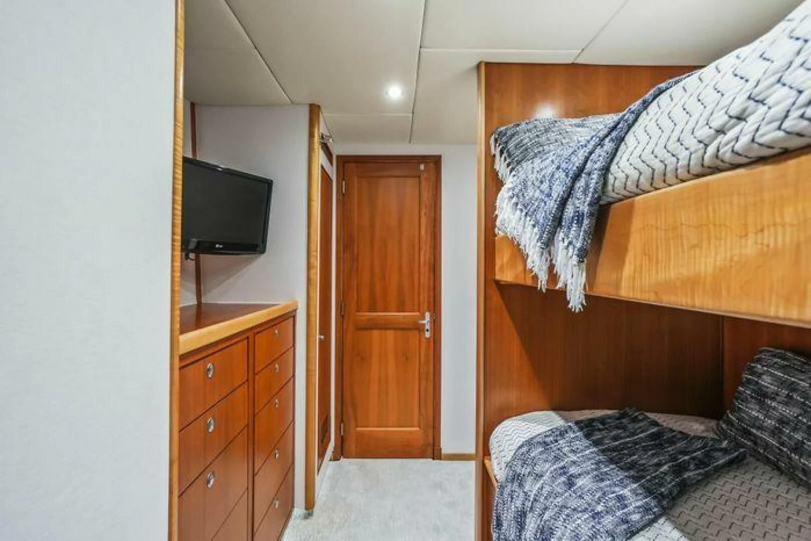 a bedroom with a bed and a television aboard ISLAND SOUL Yacht for Sale