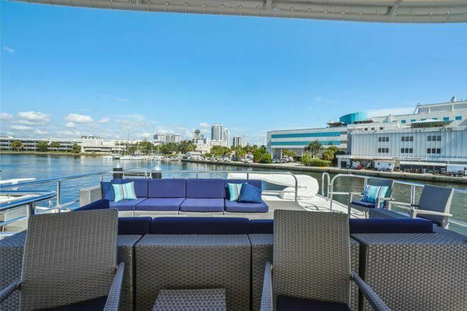 a deck with chairs and a body of water in the background aboard ISLAND SOUL Yacht for Sale