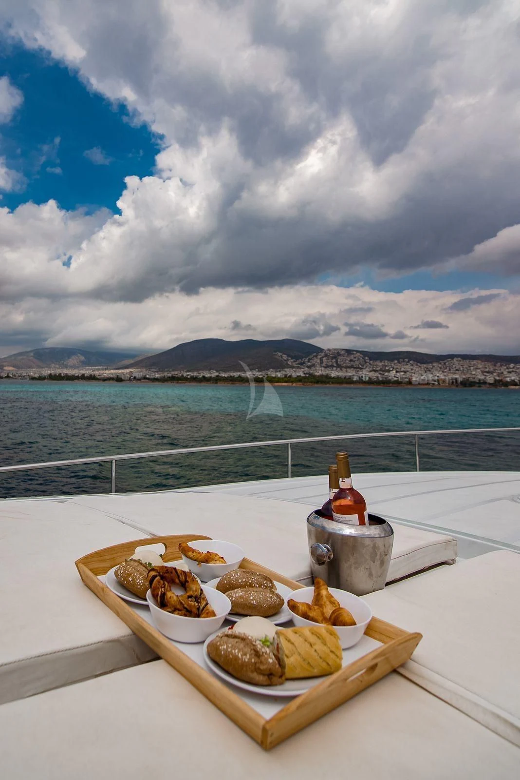 a tray of food by a body of water aboard AXION Yacht for Charter