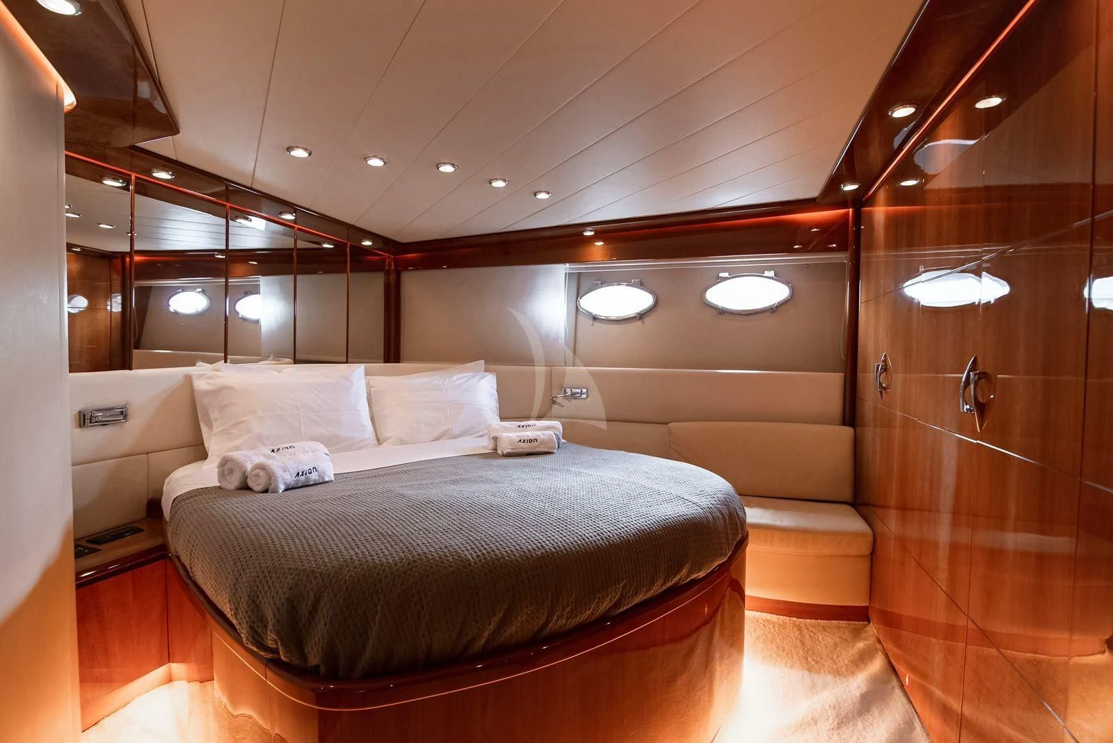 a room with a bed and a mirror aboard AXION Yacht for Charter