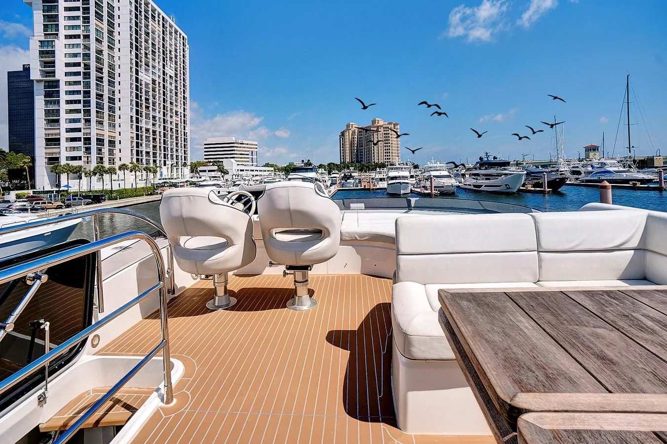 a deck with chairs and a view of a city aboard ONCE AROUND Yacht for Sale