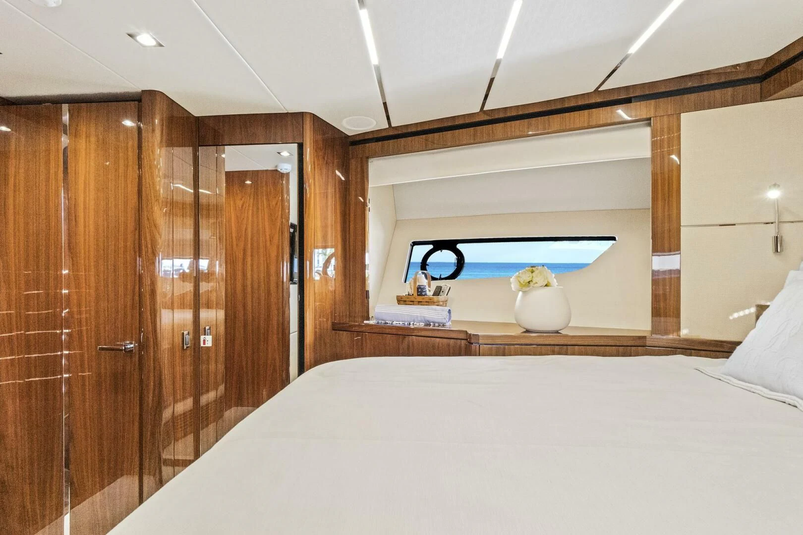 a bedroom with a bed and wooden cabinets aboard ONCE AROUND Yacht for Sale
