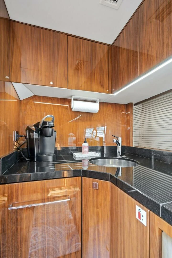 a kitchen with wooden cabinets aboard ONCE AROUND Yacht for Sale
