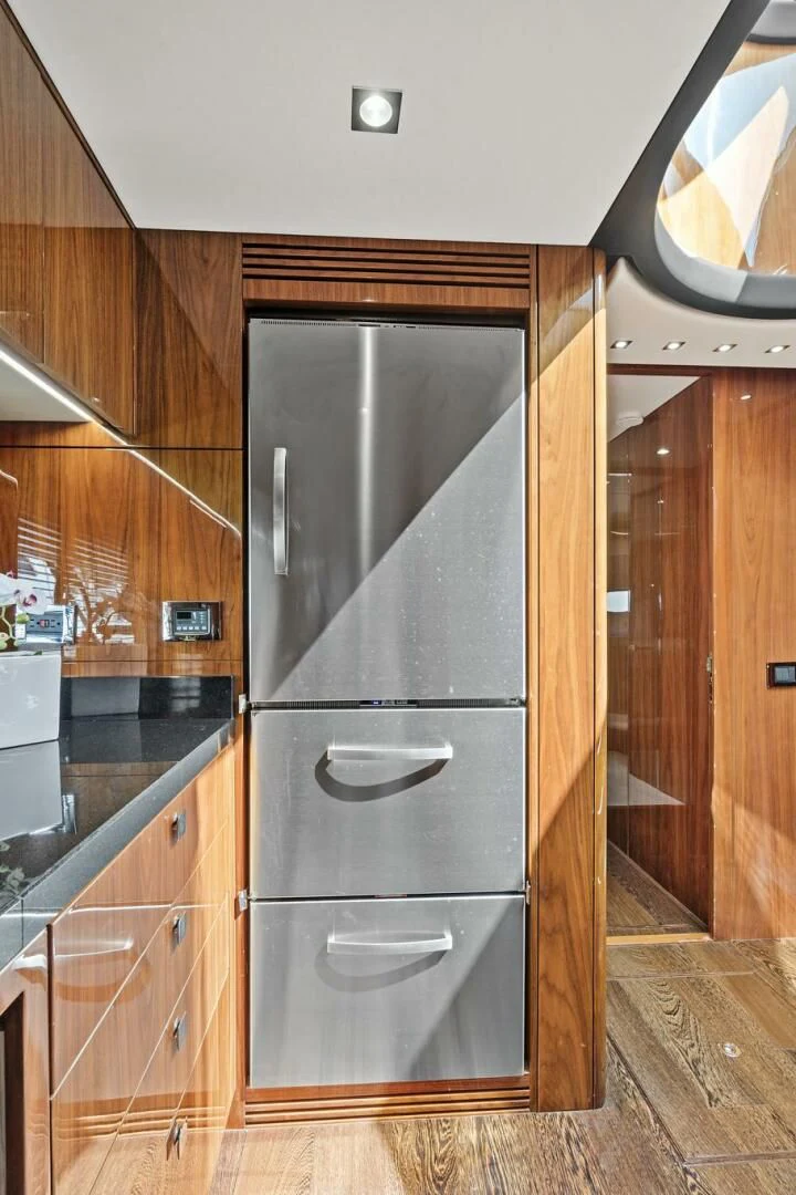 a kitchen with wooden cabinets aboard ONCE AROUND Yacht for Sale