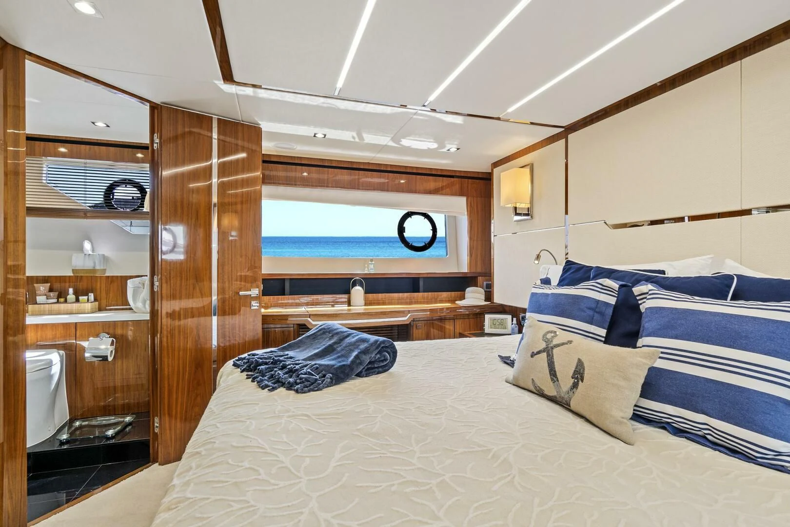 a room with a bed and a wood closet aboard ONCE AROUND Yacht for Sale