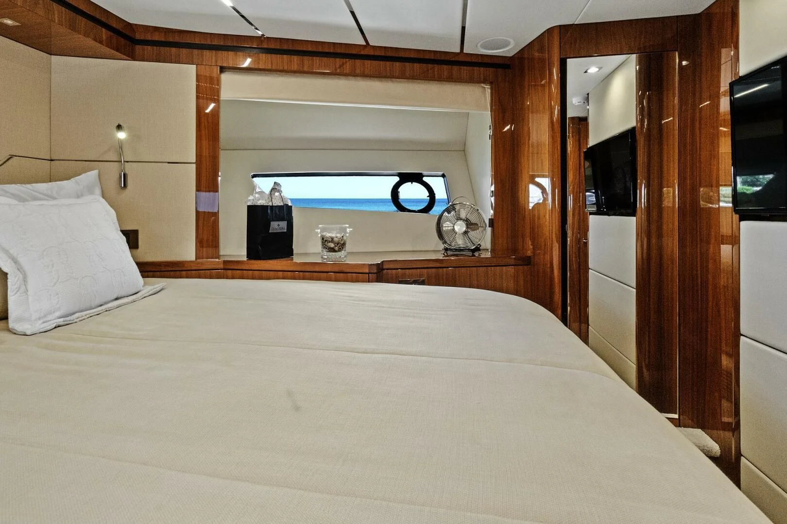 a bed with a white sheet and a blue object on the side aboard ONCE AROUND Yacht for Sale