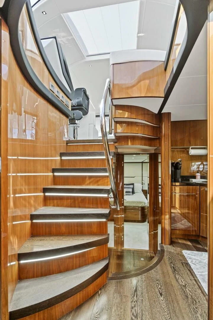 a staircase with a wood railing aboard ONCE AROUND Yacht for Sale
