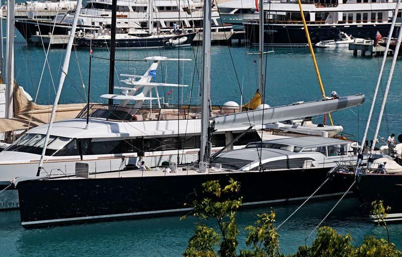 a large white boat in a harbor aboard SAUDADE Yacht for Sale