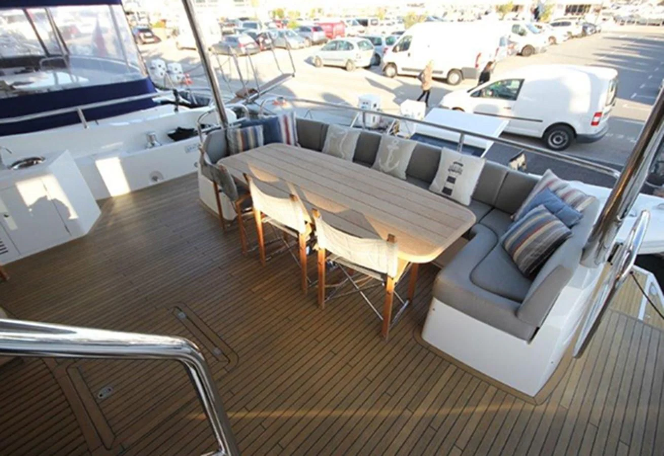 a table and chairs on a deck aboard RIANNA Yacht for Sale