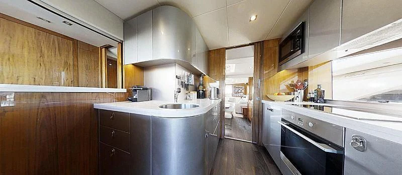 a kitchen with wooden cabinets aboard RIANNA Yacht for Sale