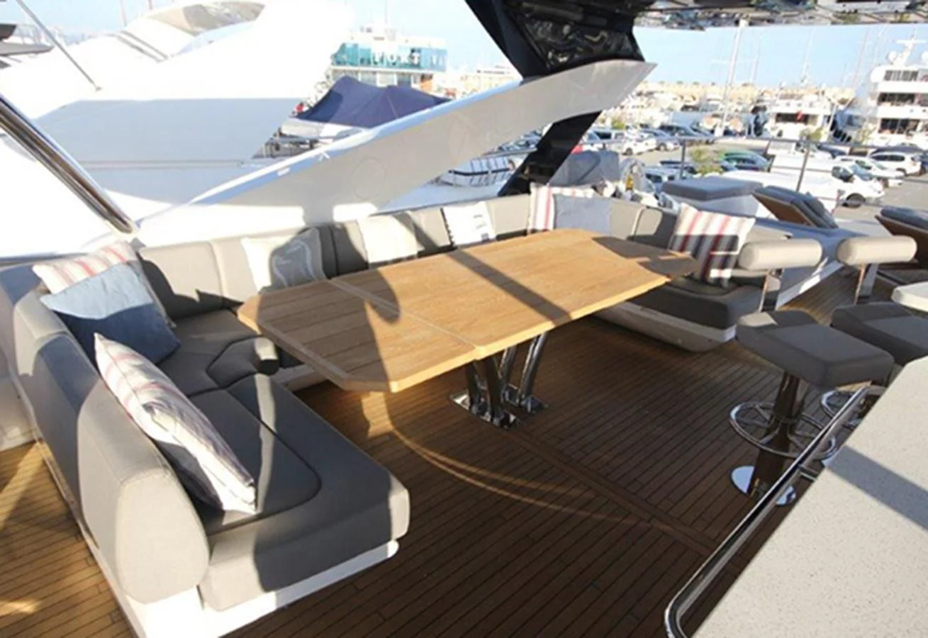 a deck with a table and chairs aboard RIANNA Yacht for Sale