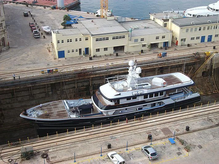 a large ship docked at a port aboard THE MERCY BOYS Yacht for Sale