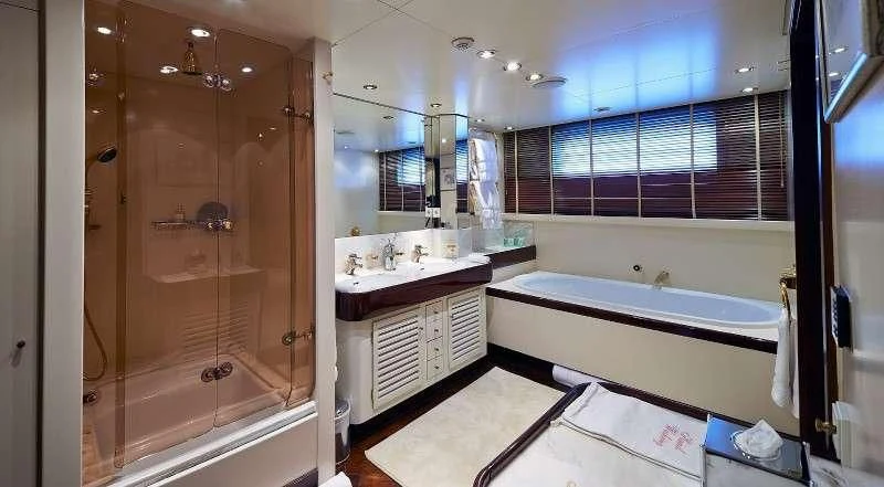 a bathroom with a tub and shower aboard THE MERCY BOYS Yacht for Sale