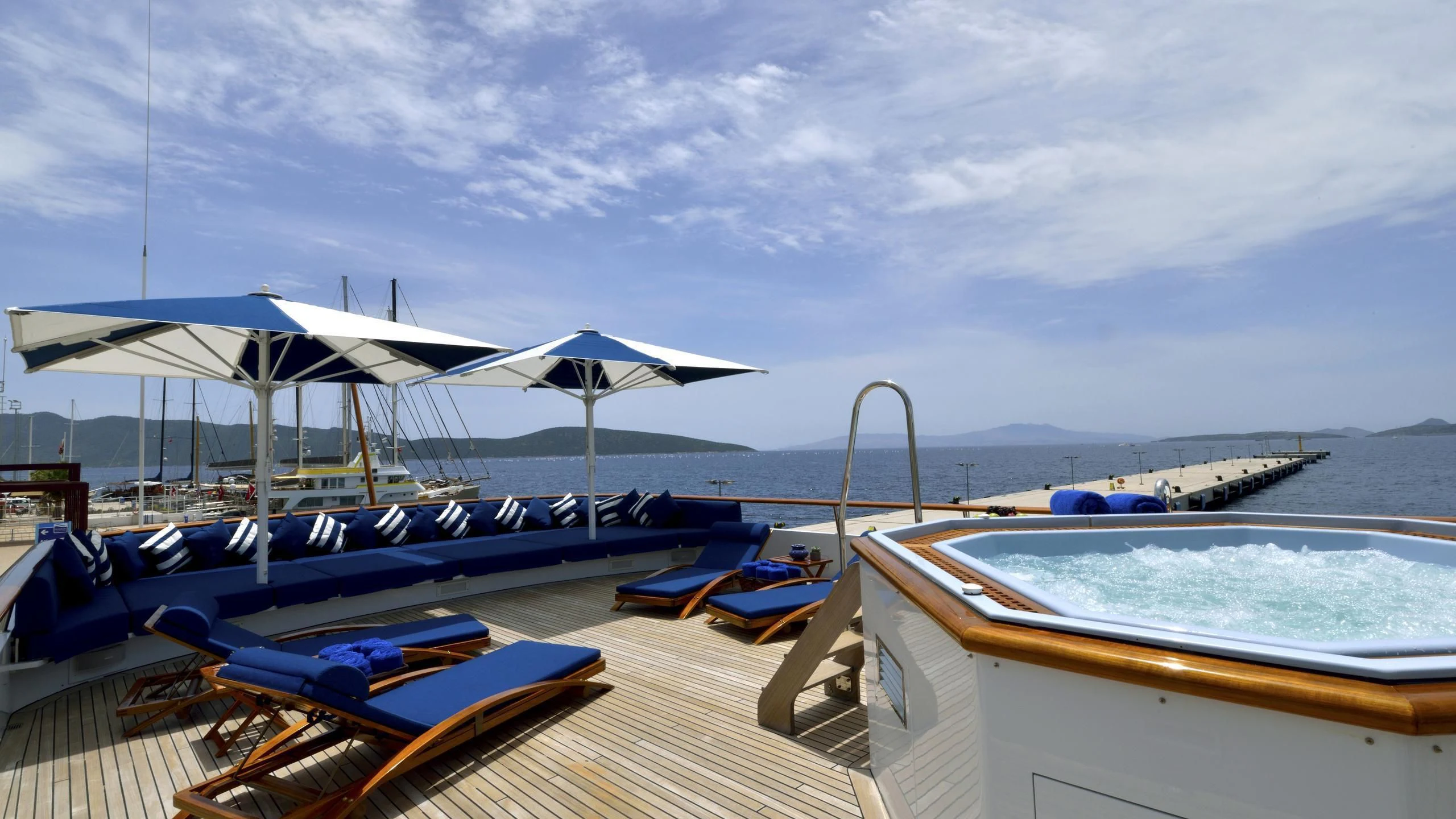 a dock with boats and umbrellas aboard THE MERCY BOYS Yacht for Sale