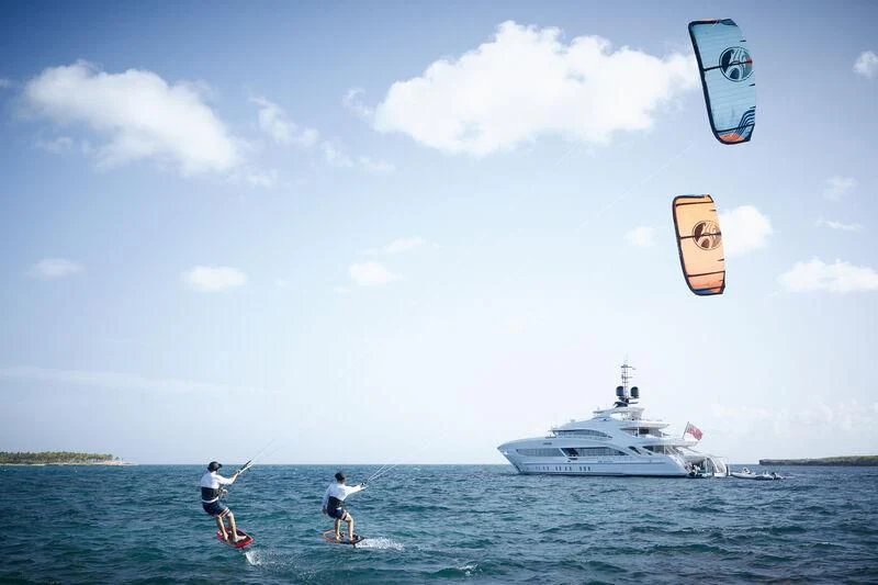 a couple of people parasailing aboard ARKADIA Yacht for Charter