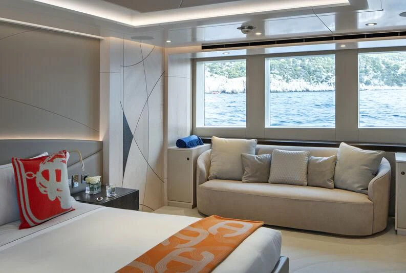 a living room with a couch and a window aboard ARKADIA Yacht for Charter