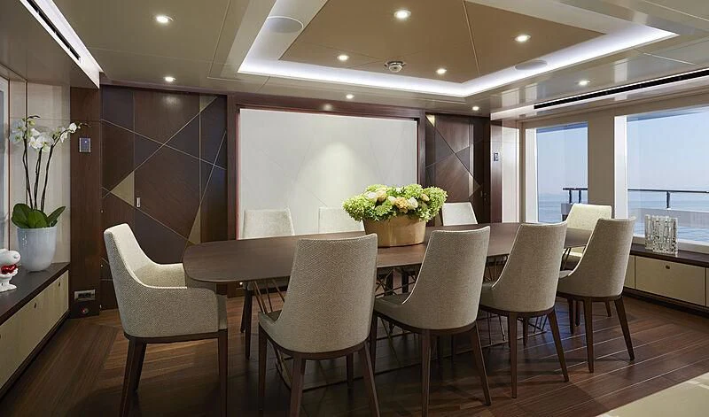 a large kitchen with a dining table aboard ARKADIA Yacht for Charter