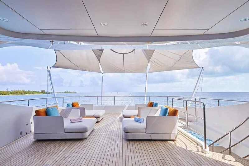 a large white tent on a deck overlooking a body of water aboard ARKADIA Yacht for Charter