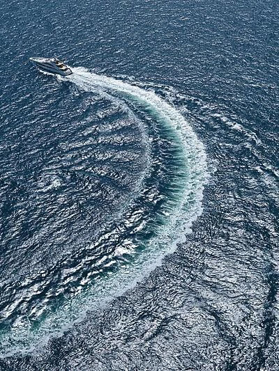 a plane flying over a beach aboard ARKADIA Yacht for Charter