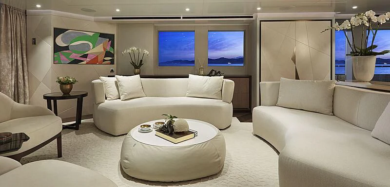 a living room with a white couch and a white coffee table aboard ARKADIA Yacht for Charter